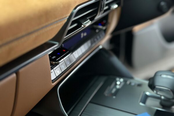 A/C close up of brown leather dashboard of a car